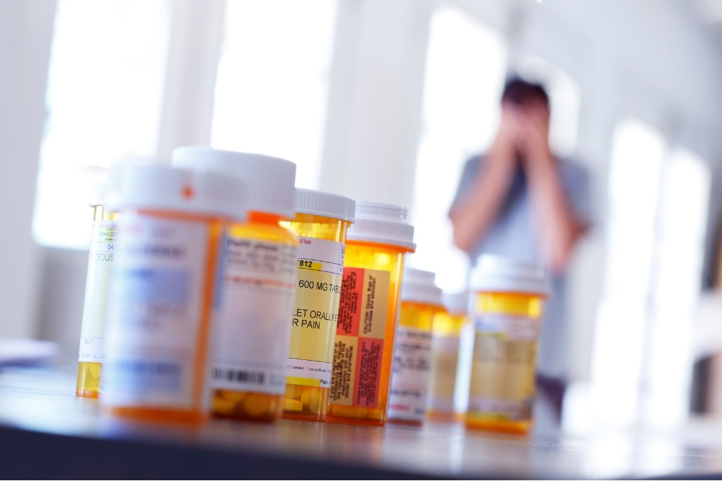 Person taking migraine medication while exploring long-term migraine treatment physiotherapy management options